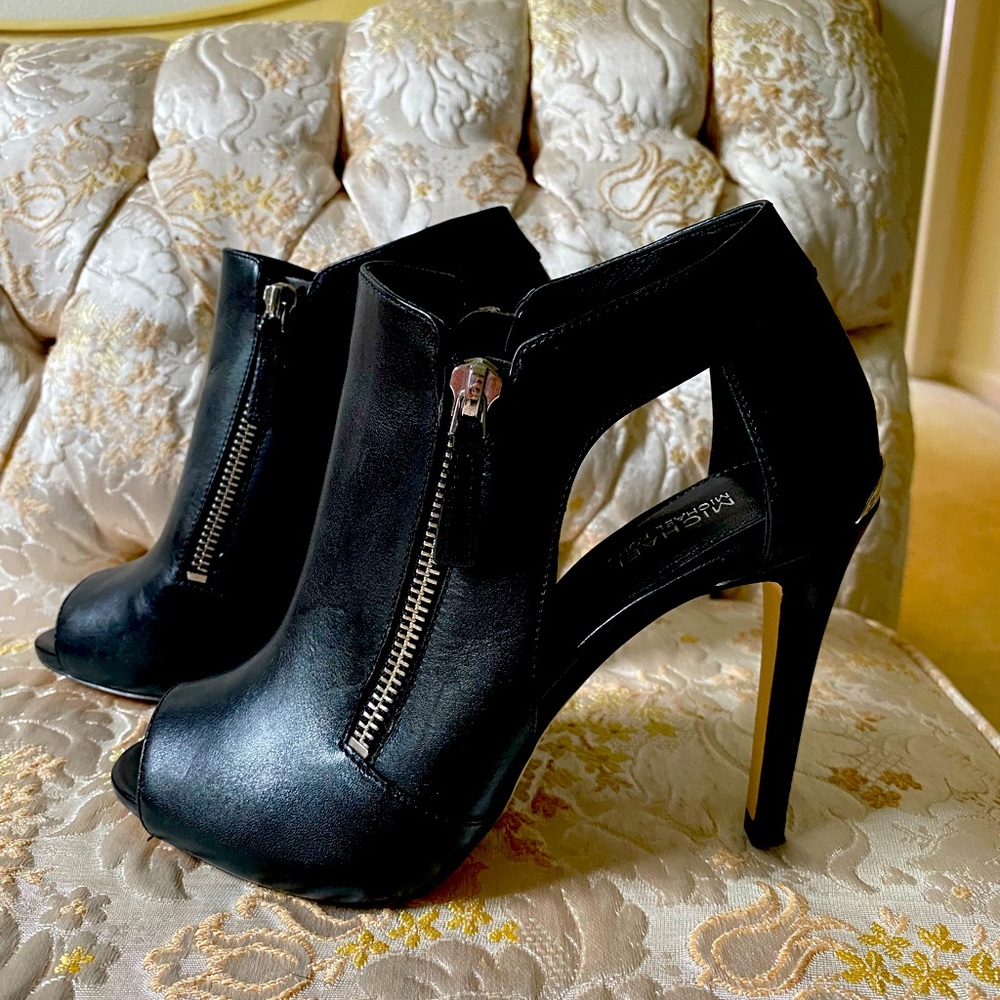 Micheal Kors black leather high heels with silver zippers very comfortable